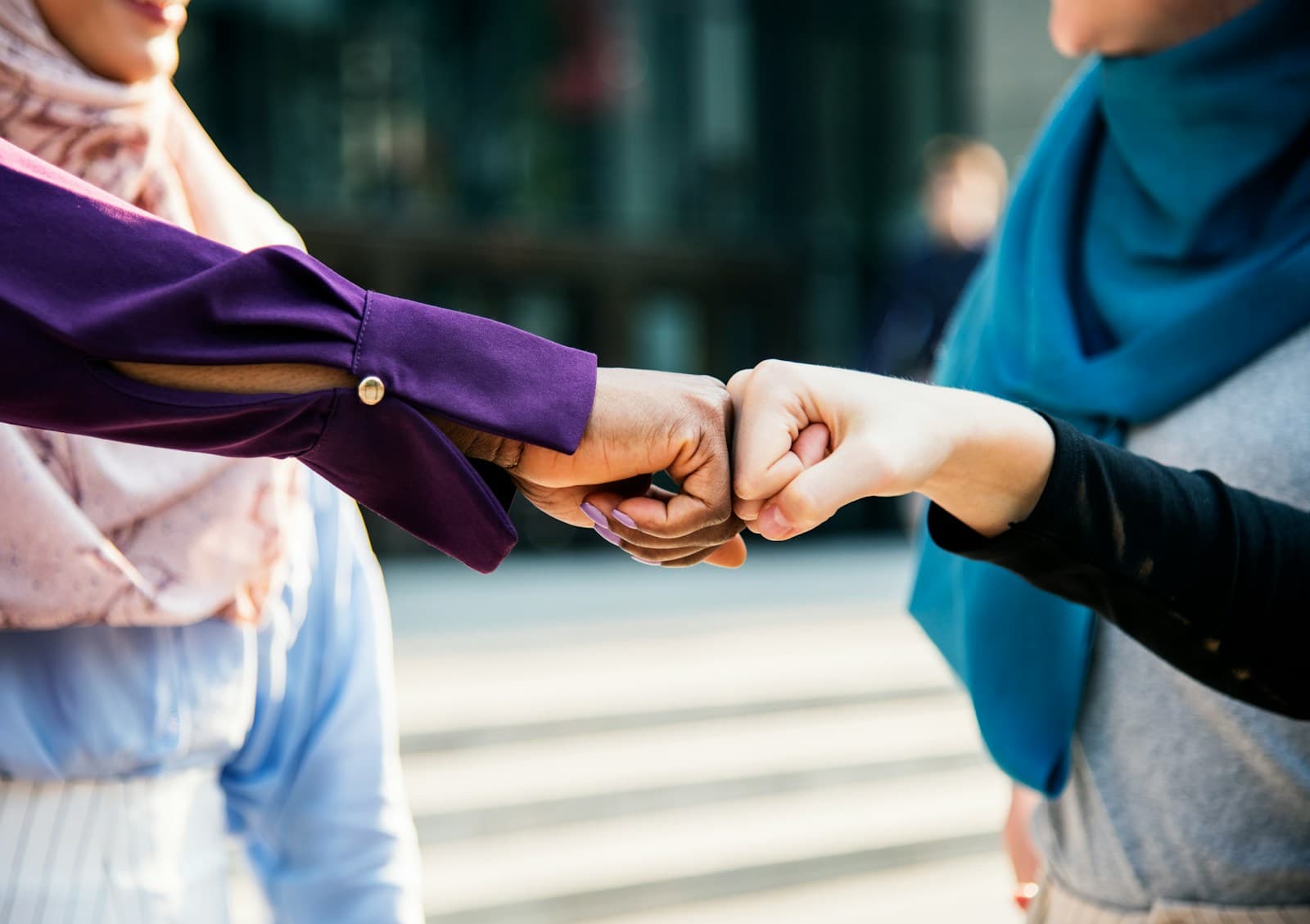 Two people fist-bumping